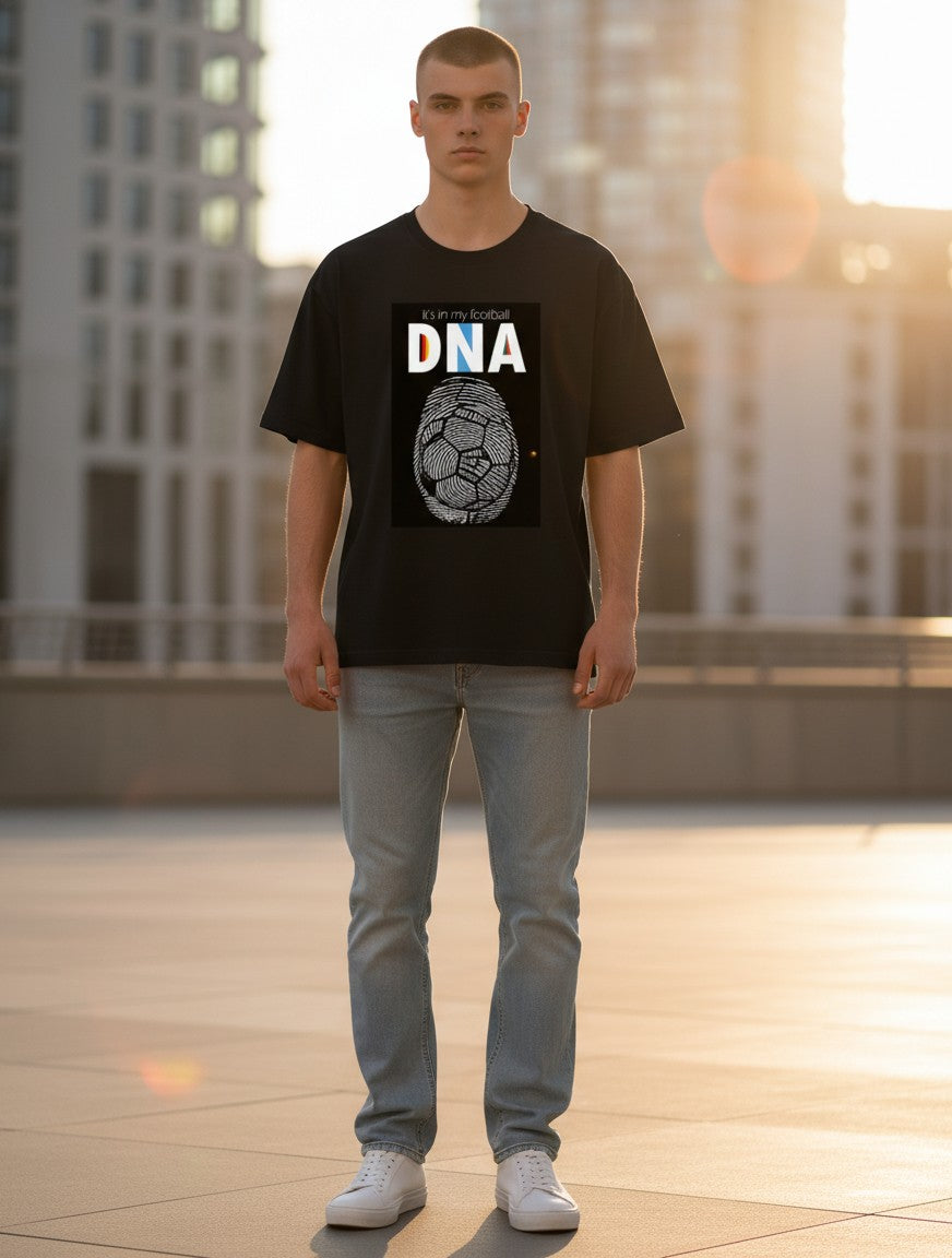 Print 999 black cotton crewneck t-shirt with football DNA graphic print worn by a man in an urban setting.
