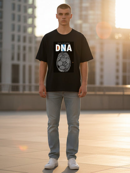 Print 999 black cotton crewneck t-shirt with football DNA graphic print worn by a man in an urban setting.