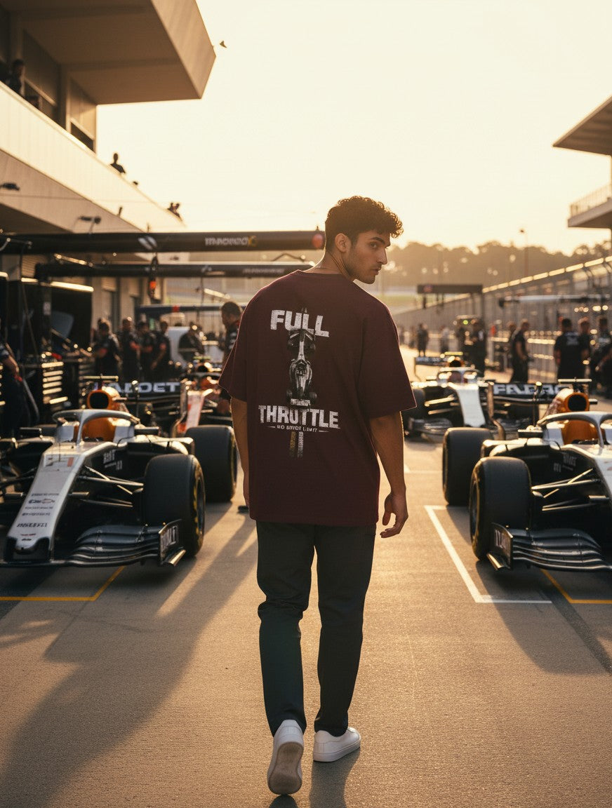 Print 999 burgundy oversized cotton t-shirt with Full Throttle graphic, worn by a man at a Formula 1 race track.