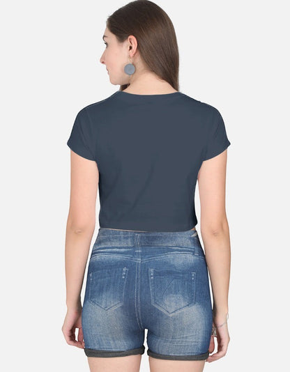 Back view of a woman wearing a Print 999 dark grey half-sleeve cotton crop top paired with denim shorts.