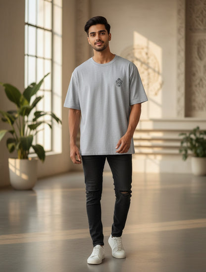 Print 999 grey oversized heavyweight cotton t-shirt with Ganesh line art, worn by a man in a bright studio.