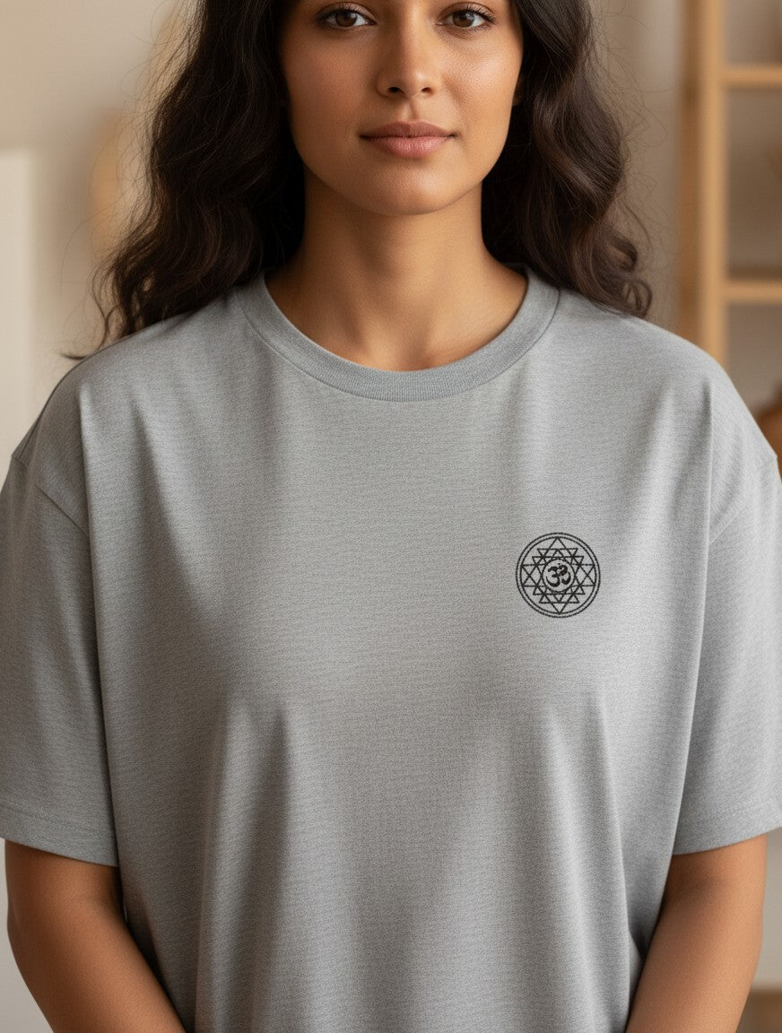 Print 999 grey oversized cotton t-shirt featuring a small black Om Sri Yantra chest print on a woman