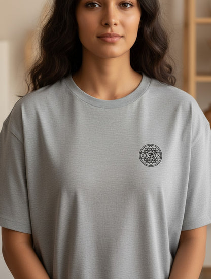 Print 999 grey oversized cotton t-shirt featuring a small black Om Sri Yantra chest print on a woman