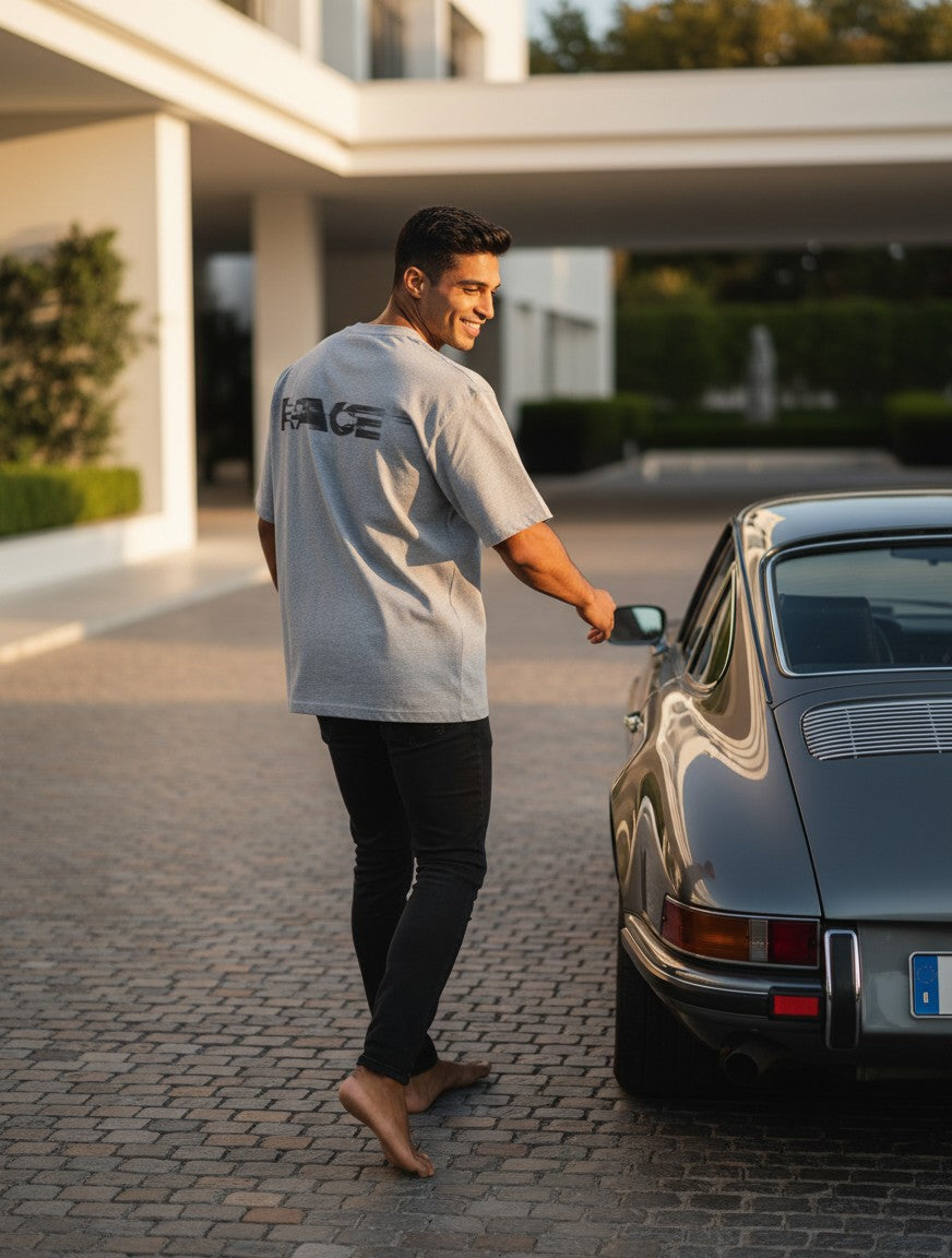 Print 999 grey oversized t-shirt with Race graphic on back worn by a man standing by a classic car