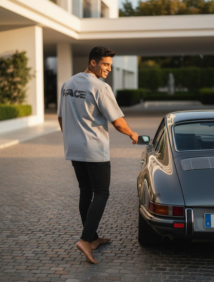 Print 999 grey oversized t-shirt with Race graphic on back worn by a man standing by a classic car