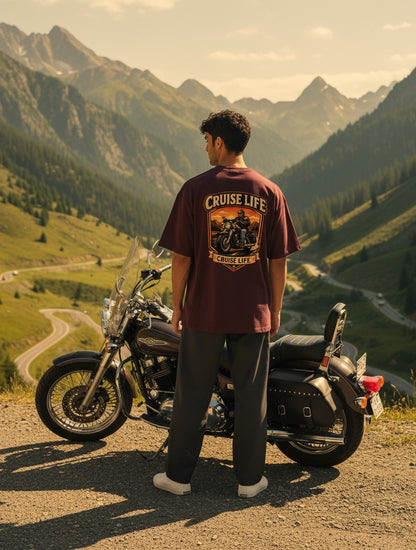 Print 999 oversized maroon cotton t-shirt with Cruise Life motorcycle graphic, worn by a man next to a cruiser bike.