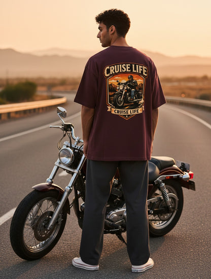 Print 999 oversized maroon cotton t-shirt with a motorcycle graphic on the back, worn by a man standing by a bike.