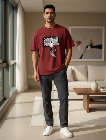 Print 999 maroon graphic t-shirt with GOAL soccer print worn by a man in a relaxed unisex fit poly-cotton blend.
