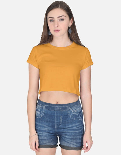 Print 999 mustard yellow half-sleeve cotton crop top worn by a model with blue denim shorts