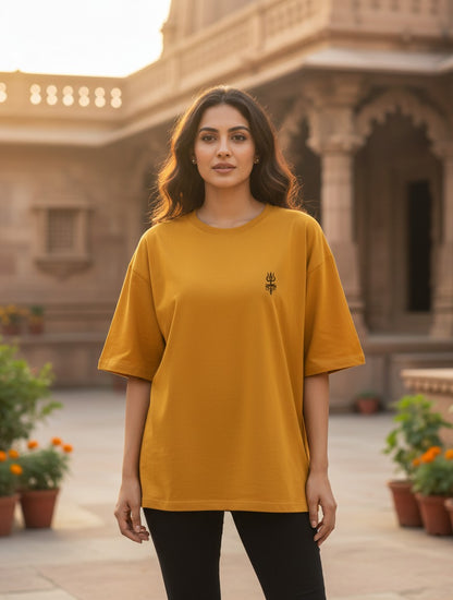 Print 999 mustard yellow oversized cotton t-shirt with a small embroidered black Trishul emblem on a woman