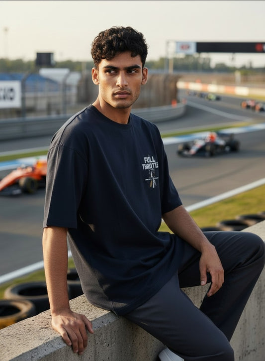 Print 999 oversized black cotton t-shirt with Full Throttle graphic, worn by a man at a racetrack.