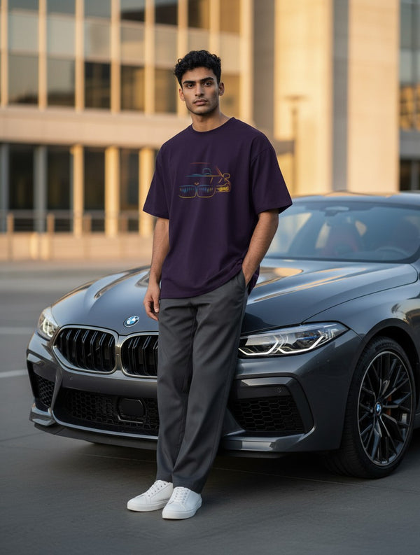 Print 999 oversized purple cotton t-shirt with neon car graphic worn by a man leaning against a luxury car.