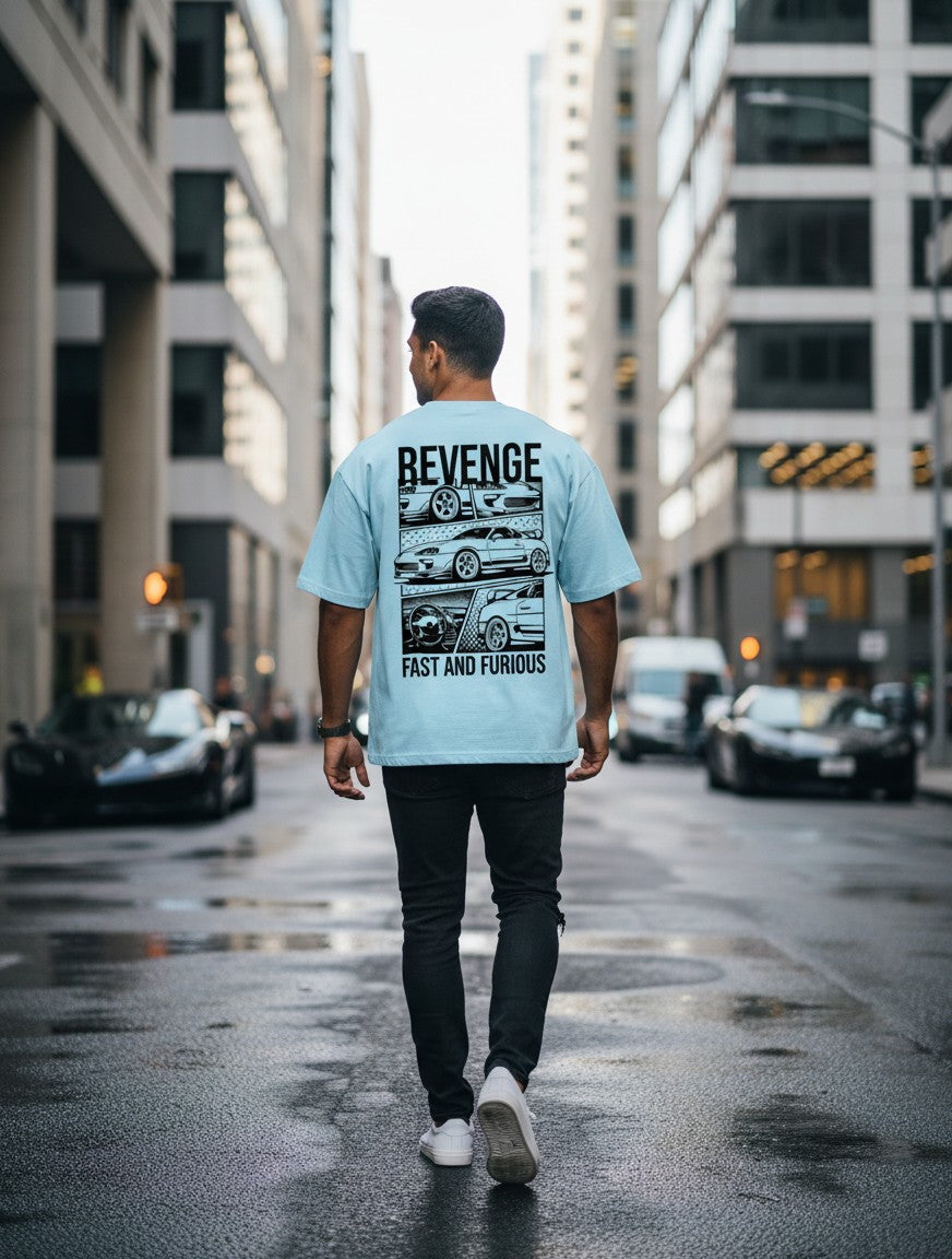 Man wearing Print 999 light blue oversized cotton t-shirt with street racer car graphic on back in city street