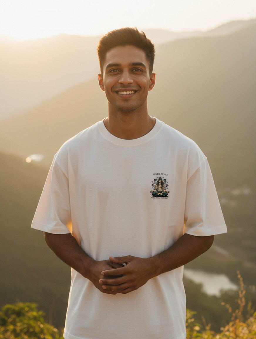 Print 999 oversized white cotton t-shirt with Peace is Power graphic worn by a smiling man at sunset.