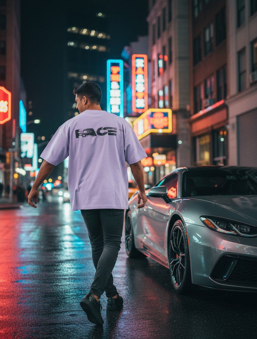 Print 999 light purple oversized t-shirt with back graphic worn by a man walking on a city street at night