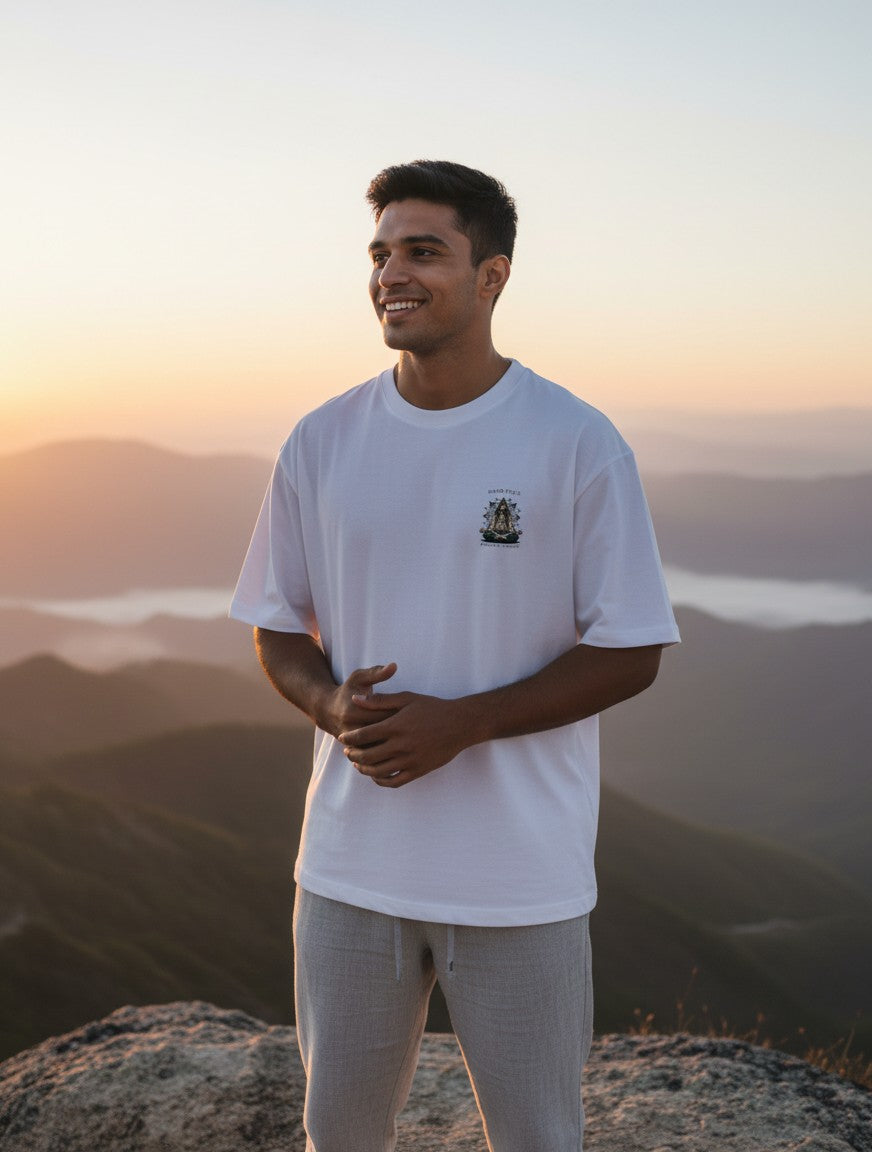 Print 999 white heavyweight cotton oversized t-shirt with graphic print worn by a man at sunset on a mountain peak