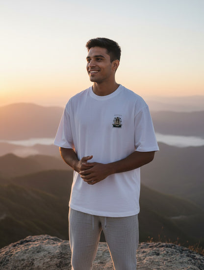 Print 999 white heavyweight cotton oversized t-shirt with graphic print worn by a man at sunset on a mountain peak